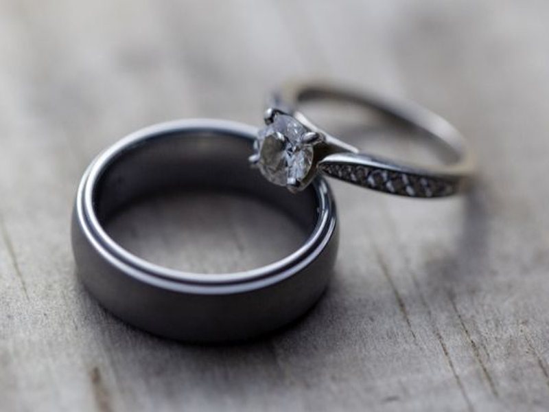 Aliança de casamento e anel de noivado sobre madeira